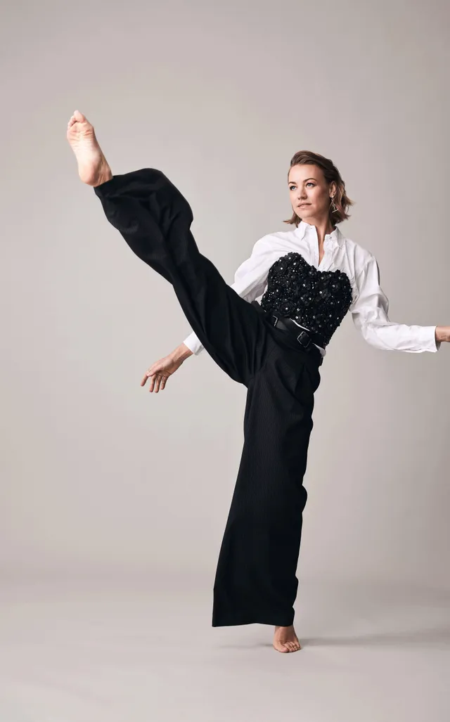 Yvonne Strahovski posing with a raised leg for a studio portrait.