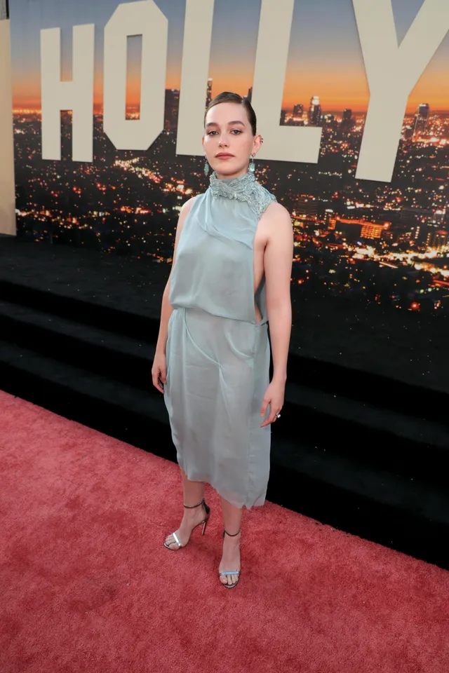Victoria Pedretti posing on a carpet in a pale blue dress.