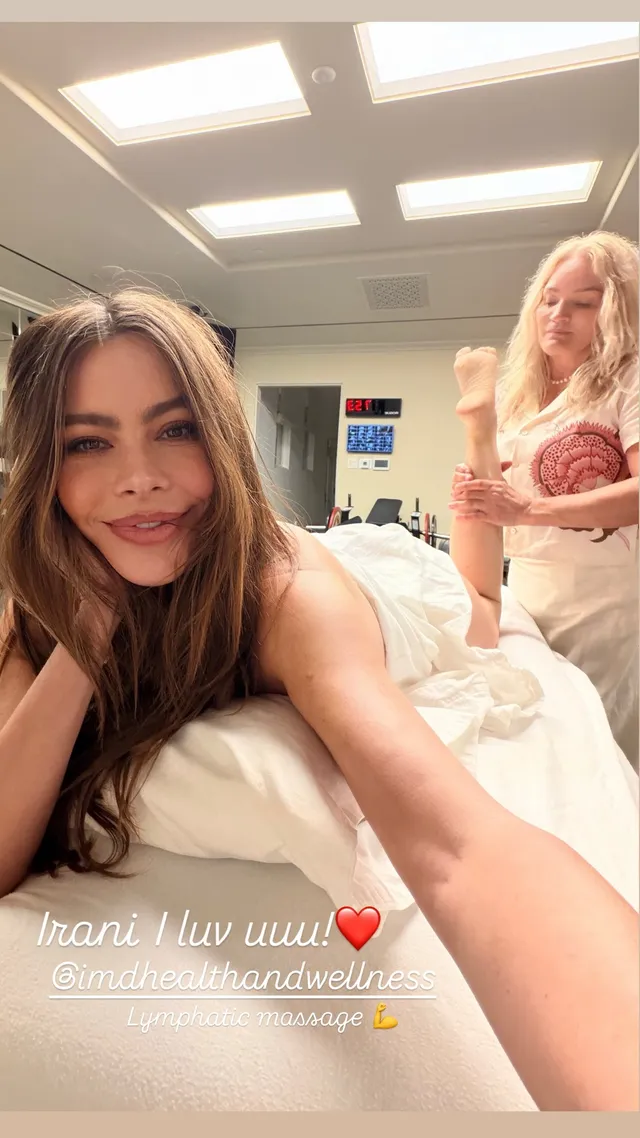Sofía Vergara reclining on a treatment bed with her bare feet raised.