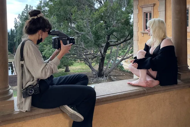 Billie Eilish a barefoot interview beside a garden window.
