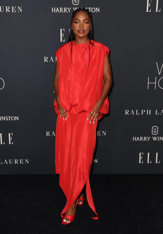 Ryan Destiny wearing a red dress and pointed red heels at an event.