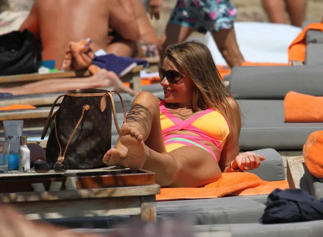 Sofía Vergara reclining outdoors with her bare soles visible.