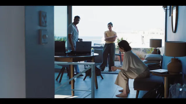 Gemma Arterton standing with other performers in a bright screen scene.