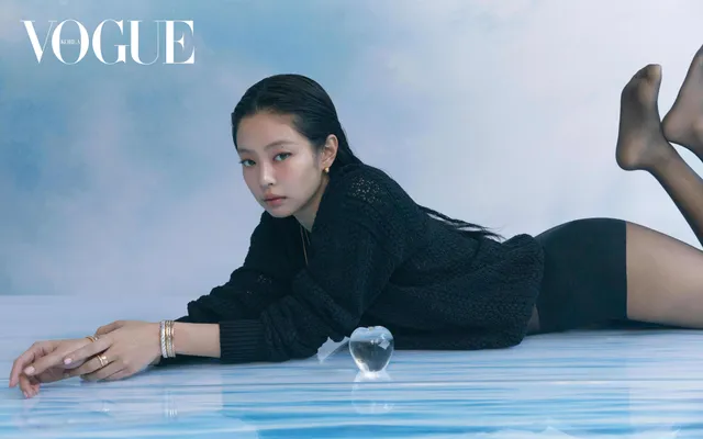 Jennie Kim lying on her front in black heels during a magazine shoot.