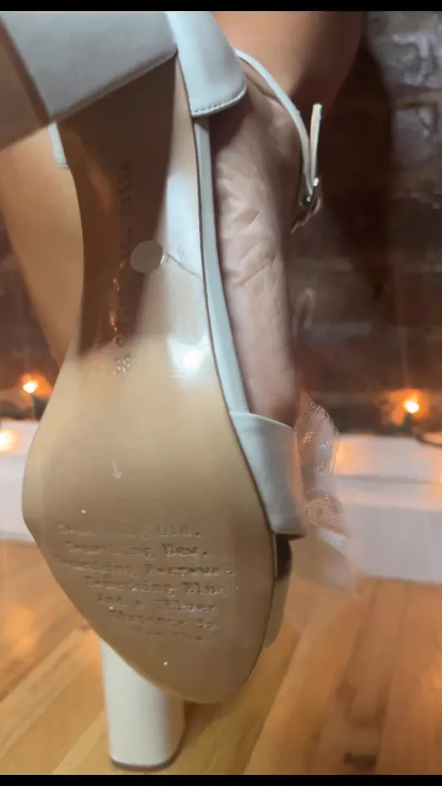 Kiana Madeira shown in a close-up of a raised white block heel.