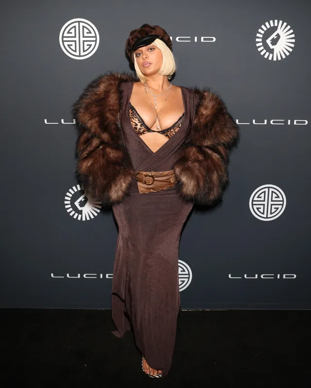Bebe Rexha wearing a brown outfit and platform heels at an event.