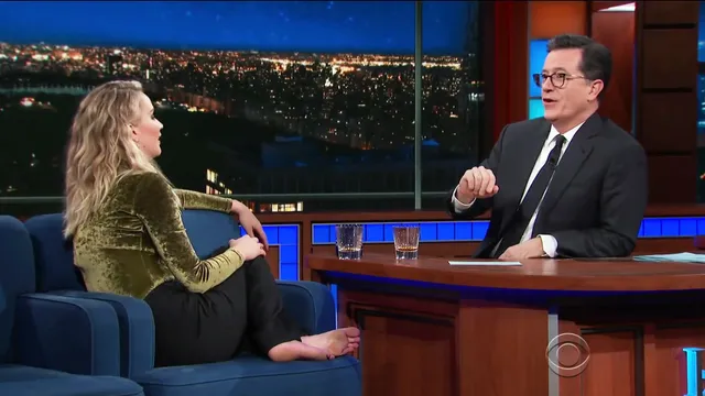 Jennifer Lawrence sitting barefoot during a television interview.