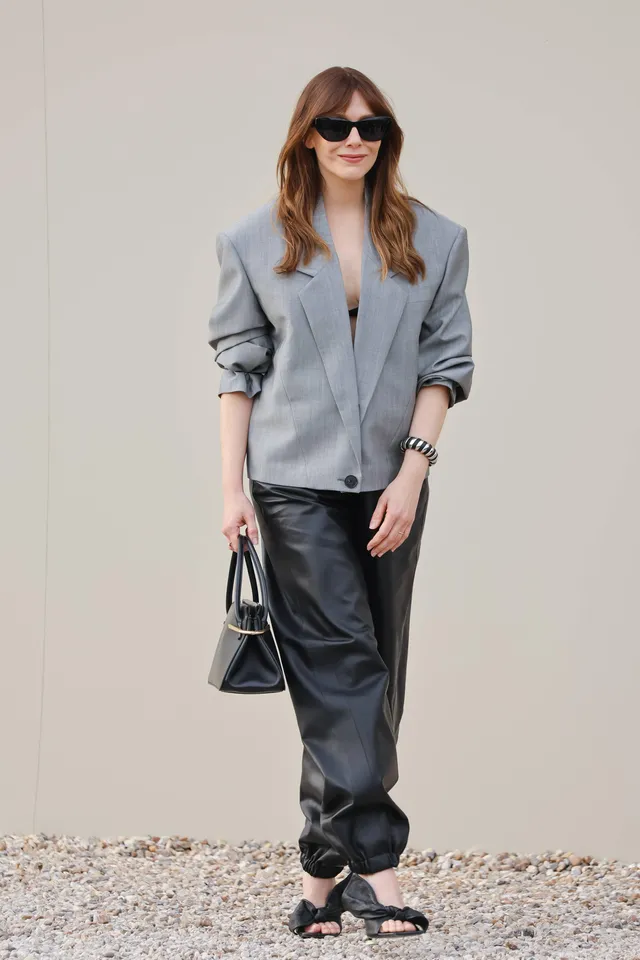 Elizabeth Olsen wearing sunglasses and black bow-front heels.