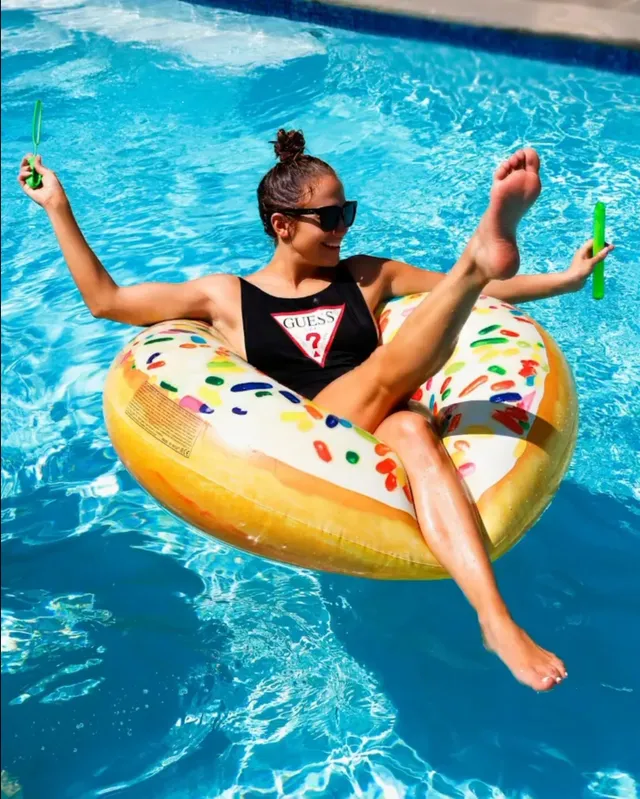 Jennifer Lopez a swimsuit photograph on an inflatable pool float.