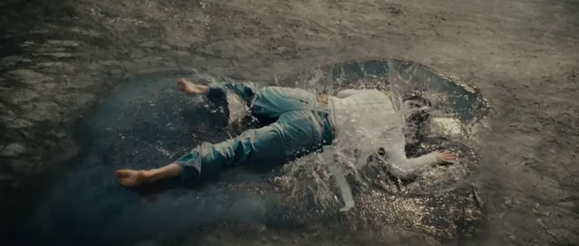 Cara Delevingne lying in a dramatic outdoor screen scene.