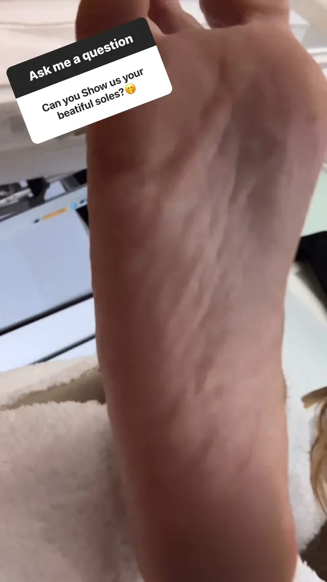 Heidi Klum showing the underside of her bare foot in close-up.