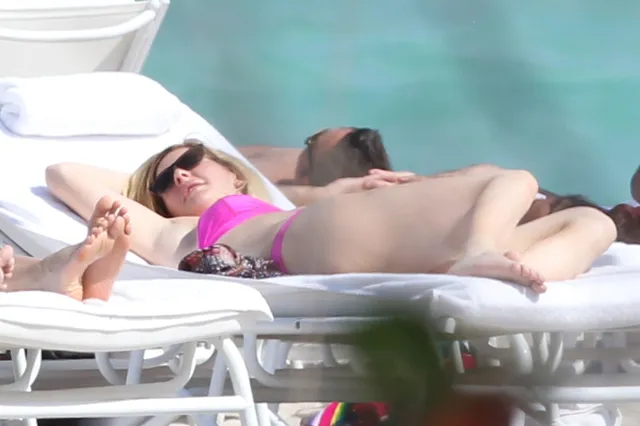 Ellie Goulding reclining barefoot on a sunlounger.