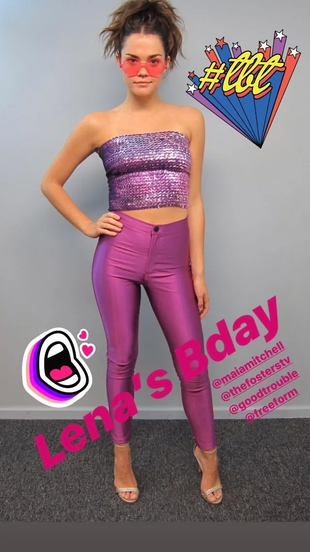 Maia Mitchell wearing a purple outfit and gold heels.