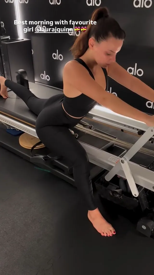 Dafne Keen exercising barefoot on a Pilates reformer.