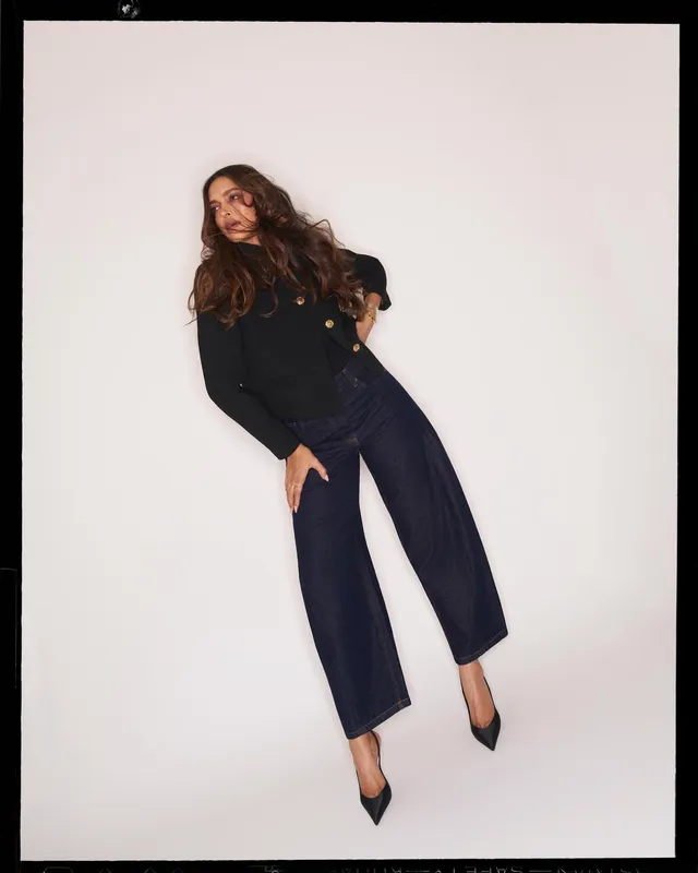 Deepika Padukone wearing black pointed heels with wide-leg dark trousers during a studio shoot.