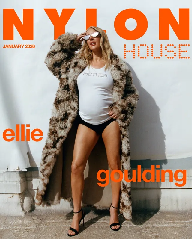 Ellie Goulding posing outdoors in black heels for a magazine cover.