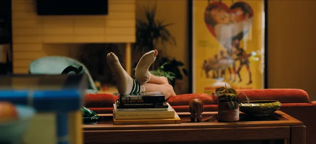Zendaya: bare soles raised above stacked books.