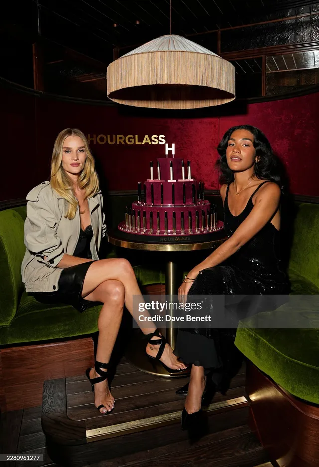 Rosie Huntington-Whiteley a seated event photograph in a pale jacket.