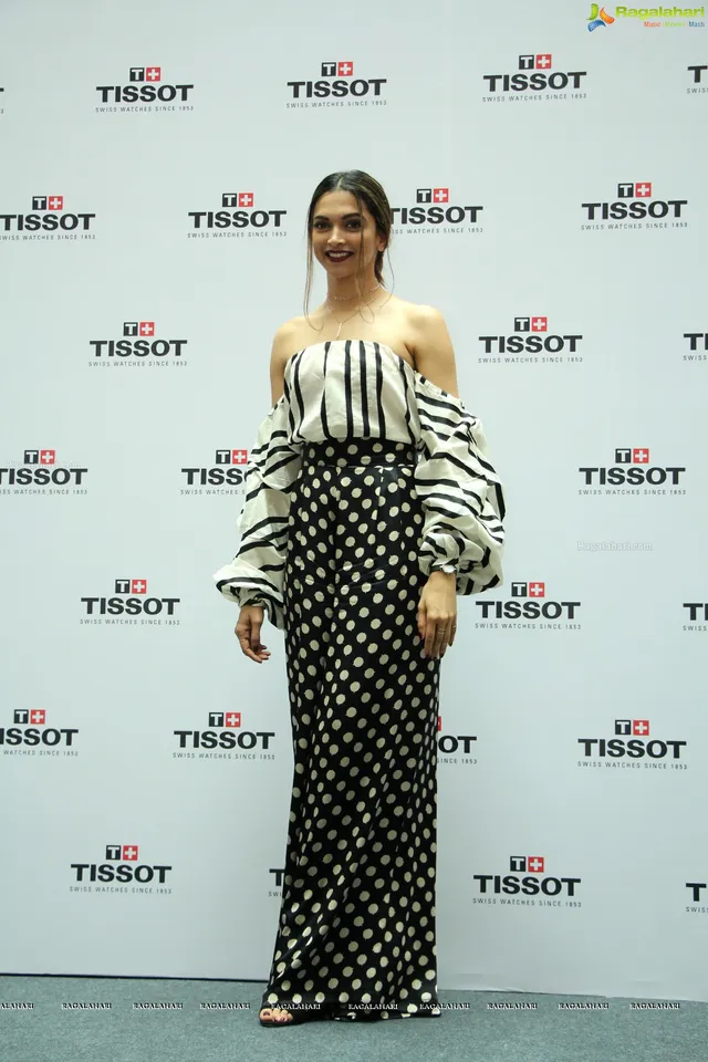 Deepika Padukone wearing black footwear with patterned wide-leg trousers at a watch event.