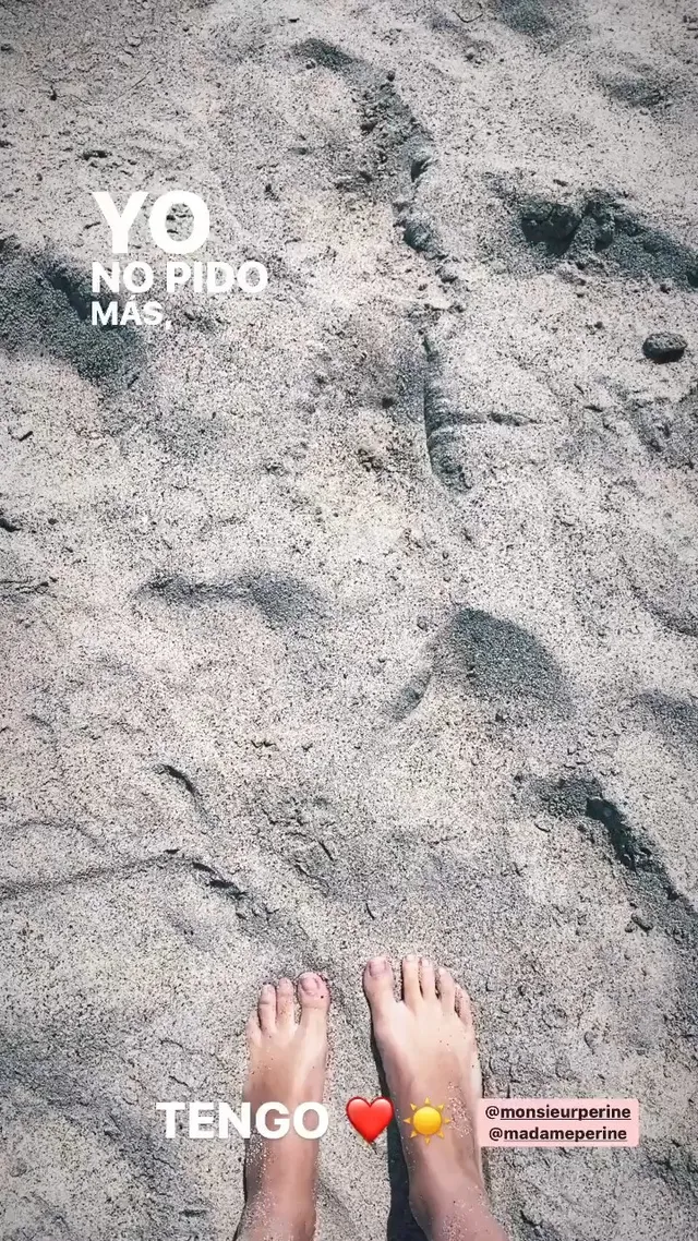 María Gabriela de Faría showing bare feet on beach sand.