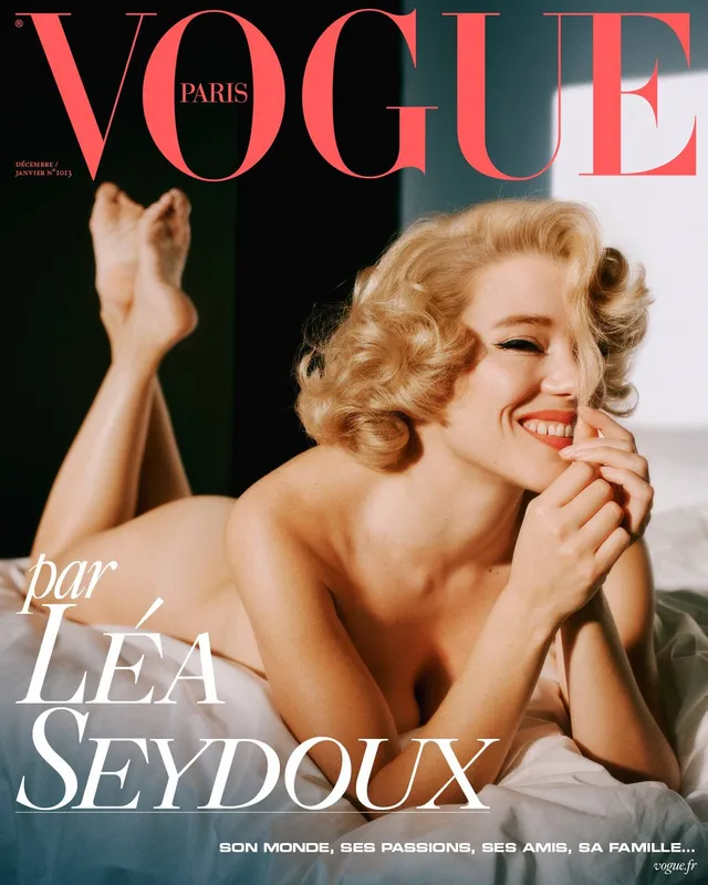 Léa Seydoux posing with her feet raised on a fashion magazine cover.