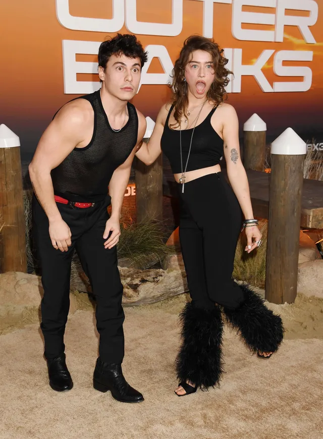 Odessa A'zion posing with a guest in furry black heels.