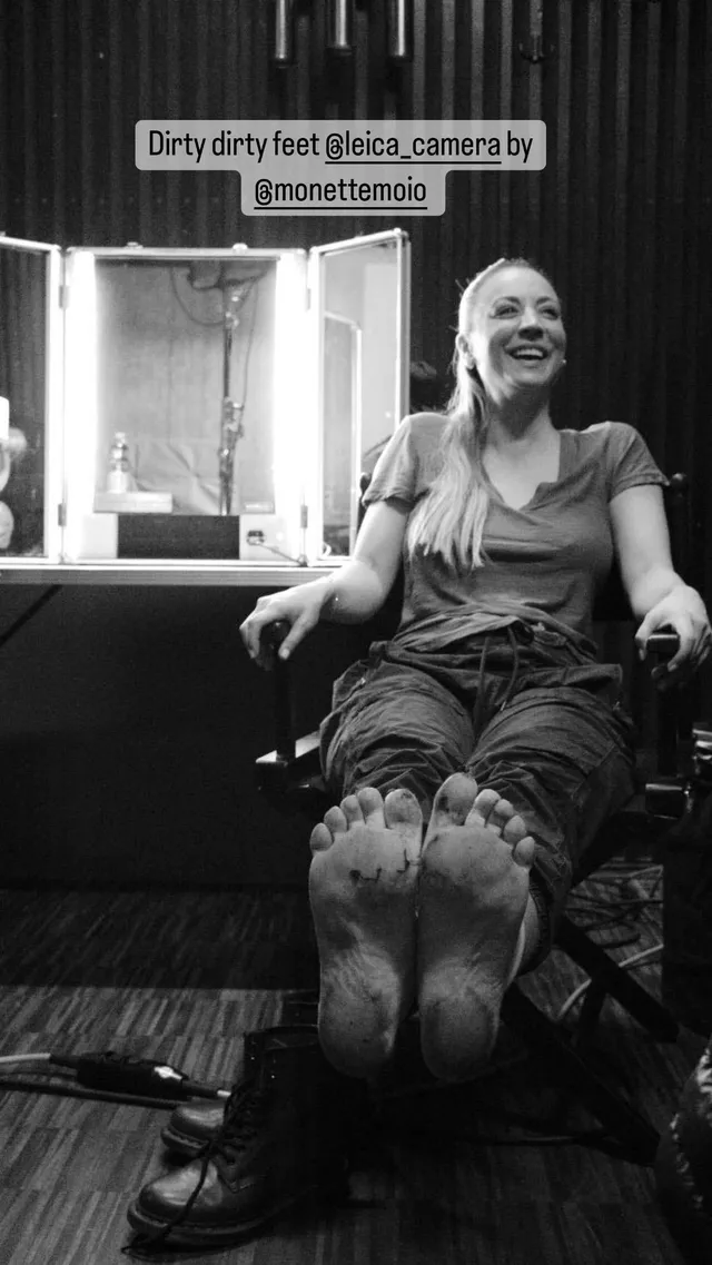 Kaley Cuoco resting her bare soles toward the camera in a monochrome pedicure photograph.