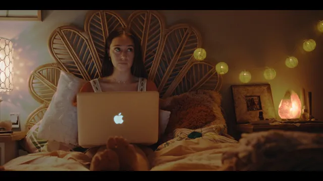 Alycia Debnam-Carey using a laptop on a bed during a screen scene.
