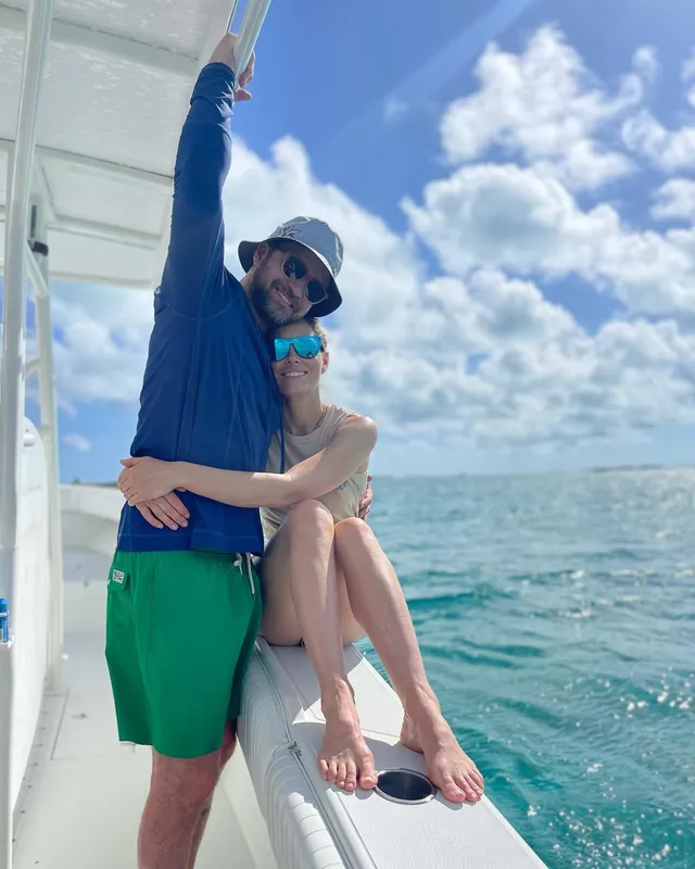 Jessica Biel seated on a boat beside a companion.