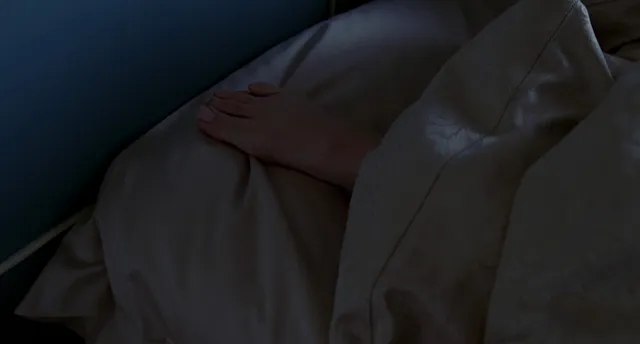 Jennifer Garner resting during a dimly lit screen scene.