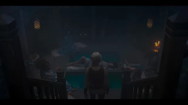 Anya Chalotra standing beside a pool in a dimly lit film scene.