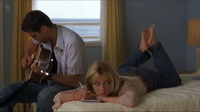 Britney Spears a reclining screen scene beside a guitarist.
