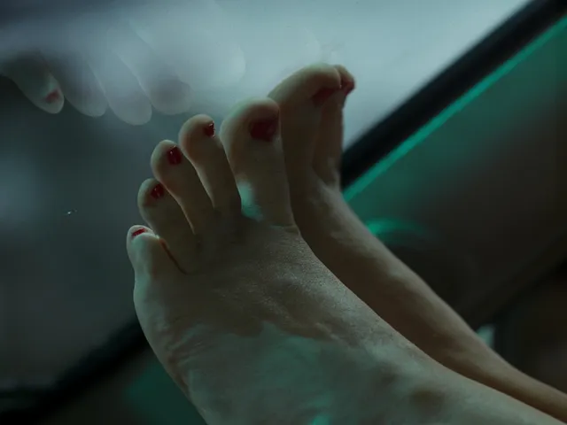 Jennifer Lawrence showing a bare foot in a close-up screen scene.