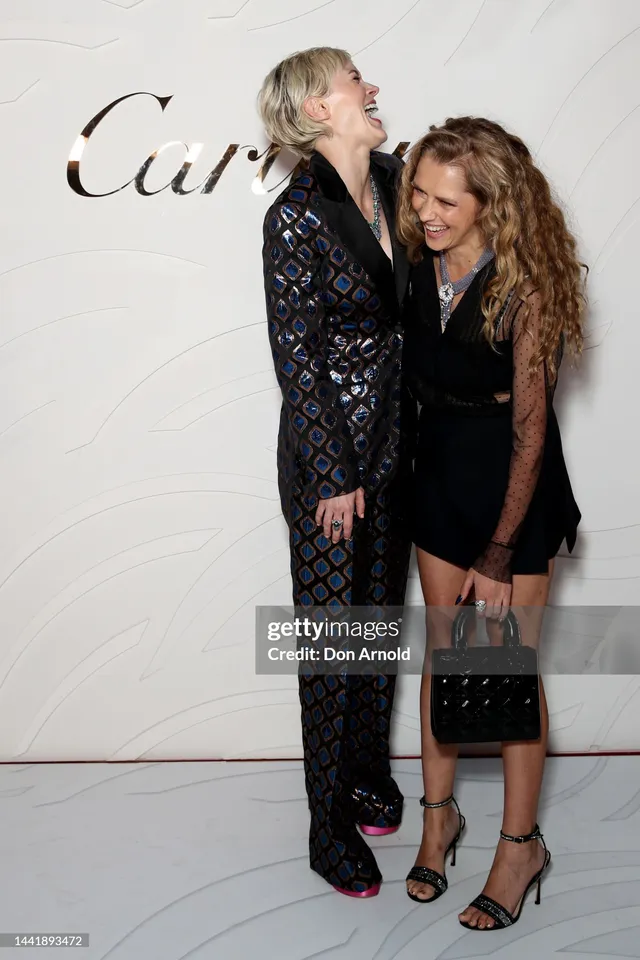 Teresa Palmer posing with a companion at a fashion event.