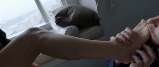 Natalie Portman resting a bare foot in a screen scene.