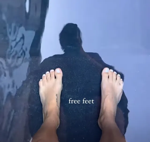 Claire Holt a casual view of bare feet above the water.