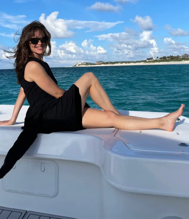 Jennifer Garner sitting on a boat in a black dress.