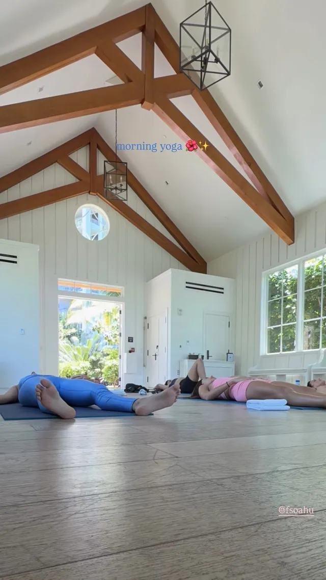 Victoria Justice stretching on an exercise mat in a bright room.