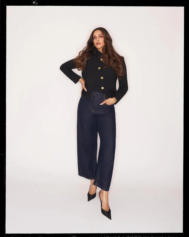 Deepika Padukone wearing black pointed heels with a dark jacket and wide-leg trousers.