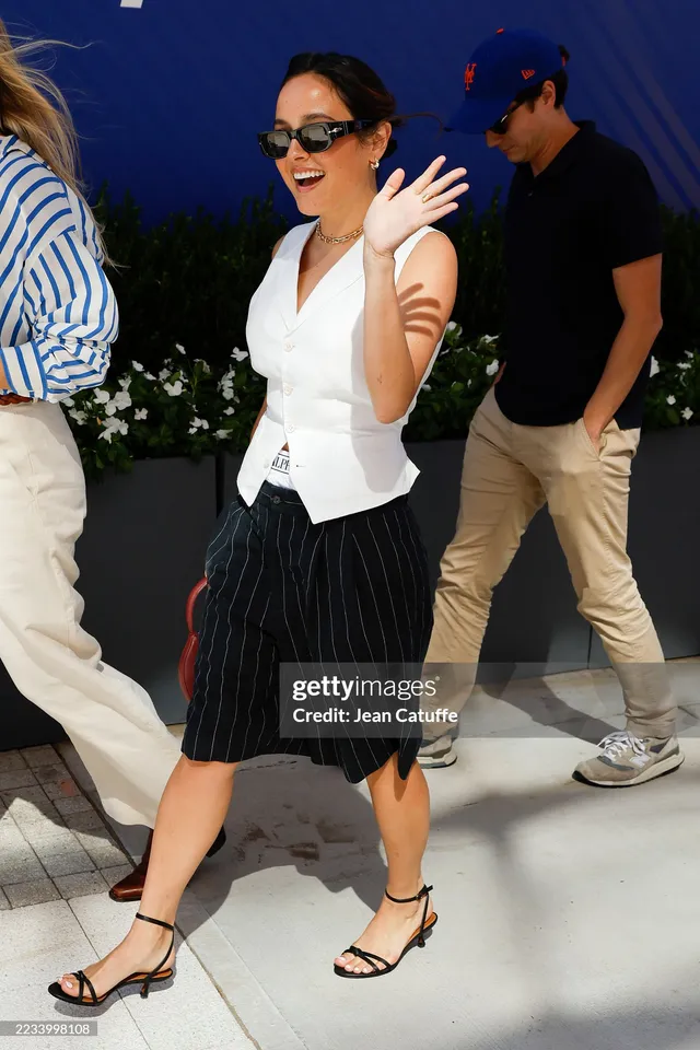 Chase Sui Wonders walking in a white vest and black heels.