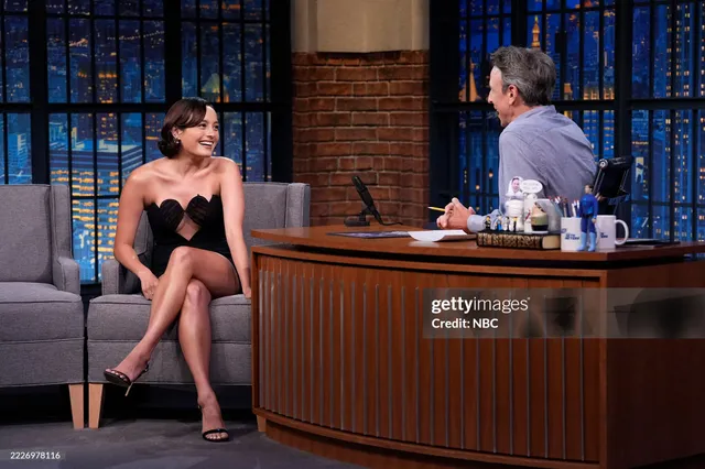 Chase Sui Wonders sitting in black heels during a television interview.