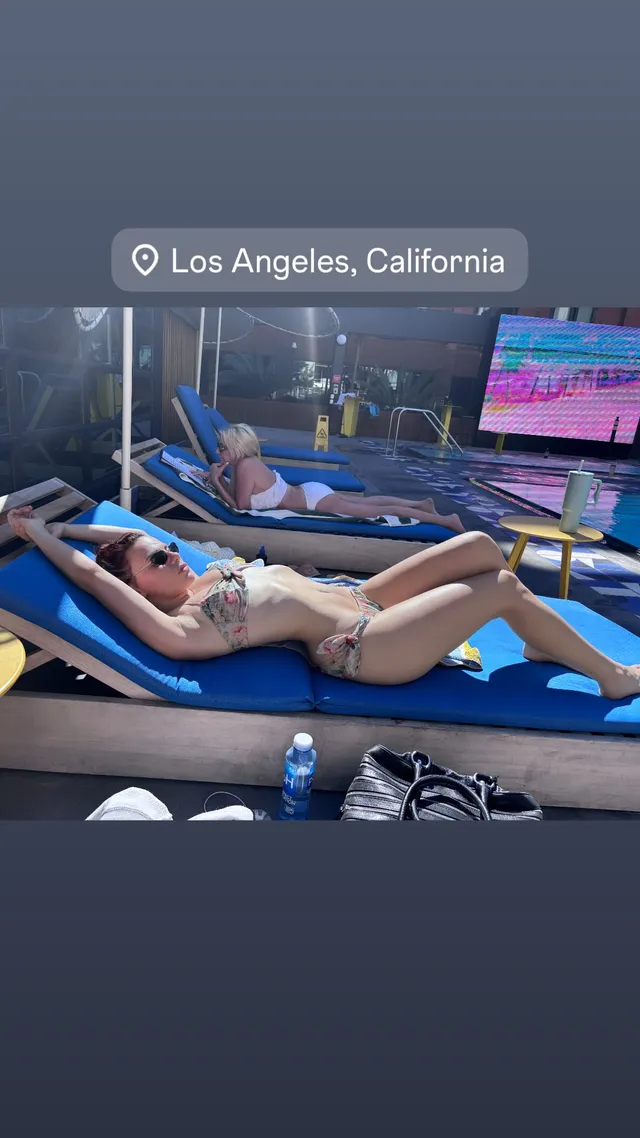 Dafne Keen relaxing barefoot on an outdoor lounger.