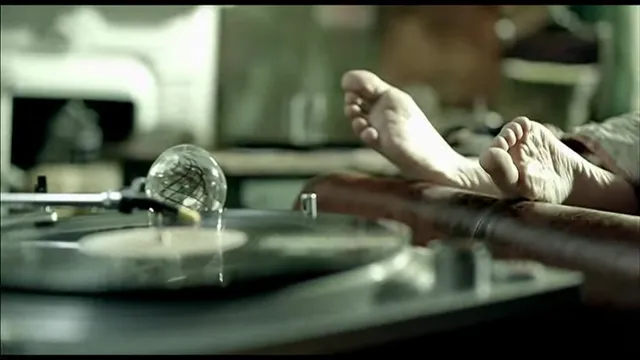 Taylor Swift: bare feet raised in a music-video scene.