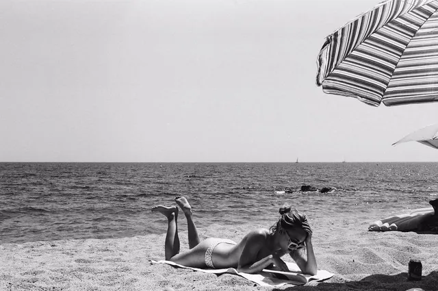 AnnaSophia Robb lying beside the sea for a black-and-white photograph.