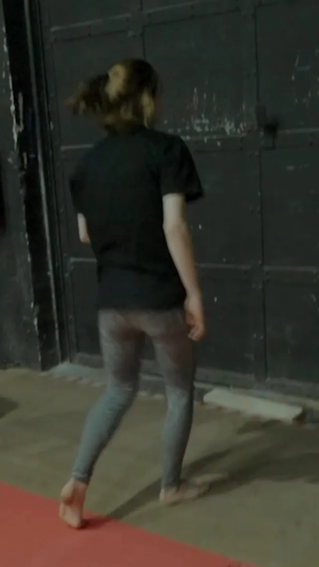 Emma Myers walking barefoot across a training mat.
