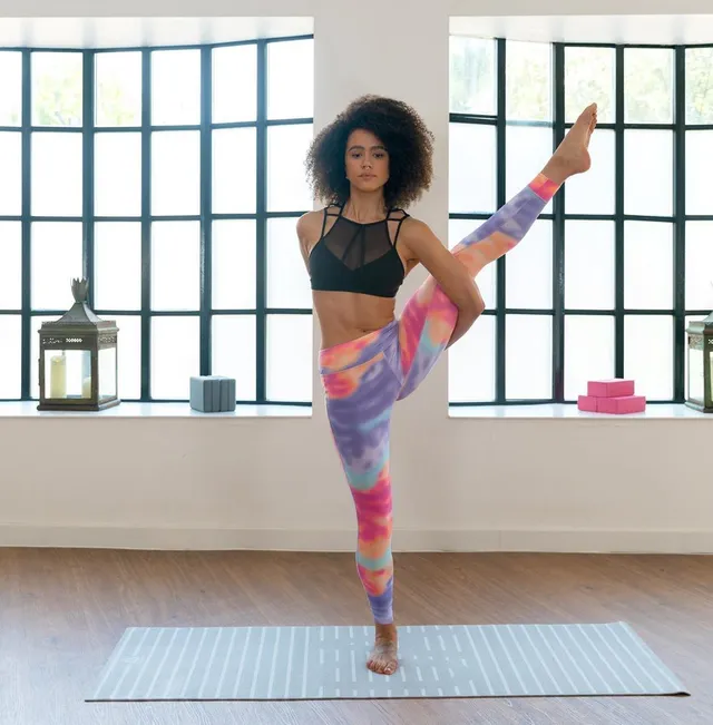 Nathalie Emmanuel balancing on one foot during an exercise shoot.