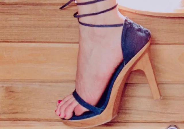 Kirsten Dunst wearing blue high-heeled sandals.