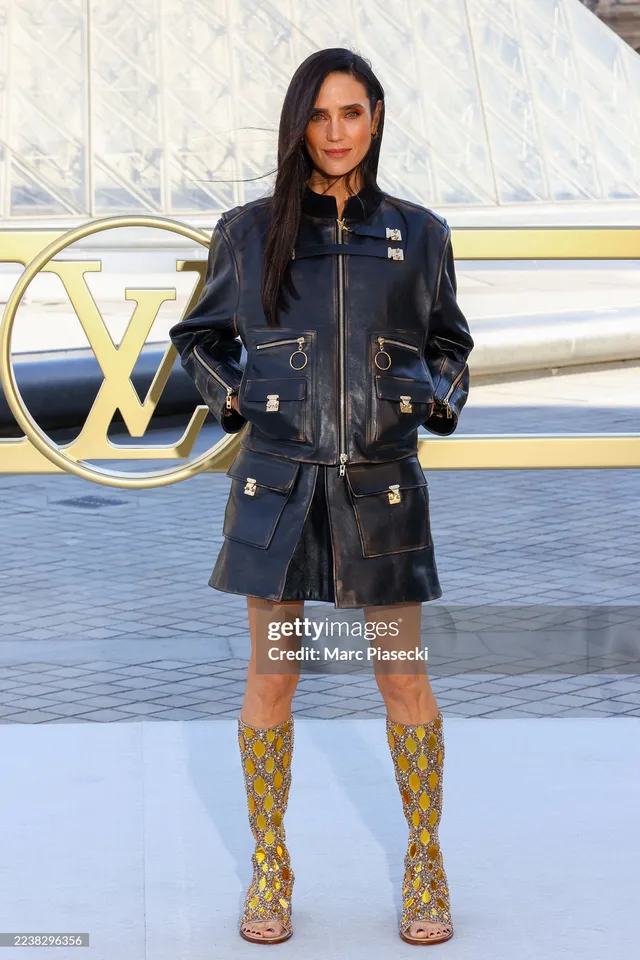 Jennifer Connelly posing at a fashion event in patterned boots.