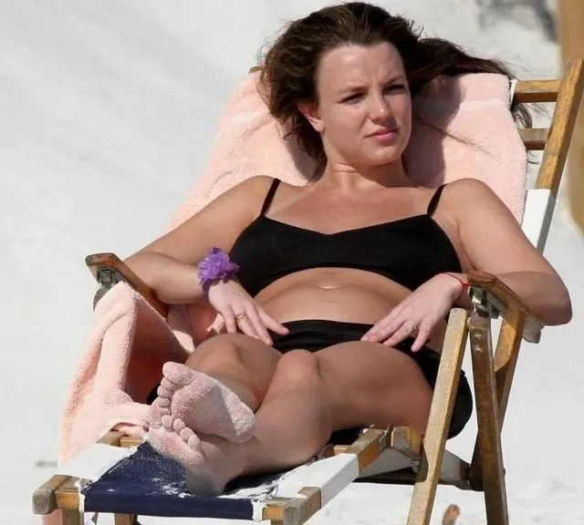 Britney Spears a swimsuit portrait in a beach chair.