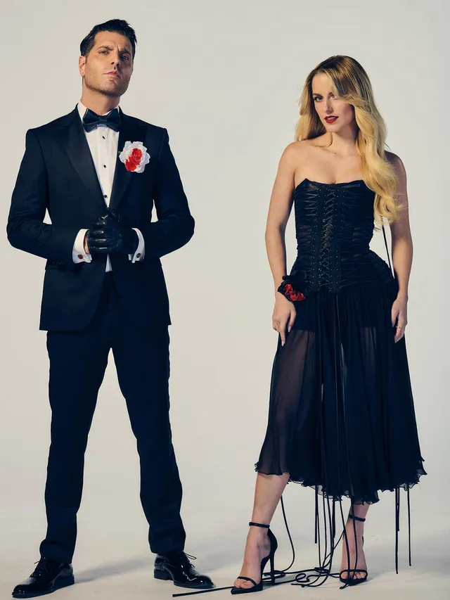 Mckenna Grace standing beside another person in a dark dress and heels.